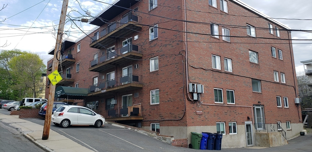 6 Hayes Road, Unit 25 Boston, MA 02131 - Photo 2 of 39 a car parked on the side of a street