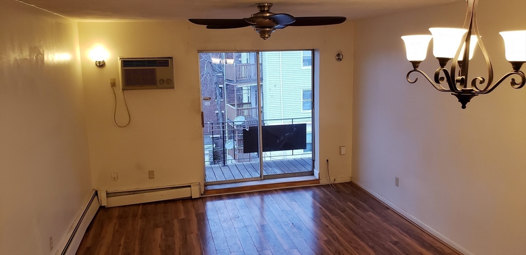 6 Hayes Road, Unit 25 Boston, MA 02131 - Photo 21 of 39 a view of a hallway with wooden floor and a bathroom