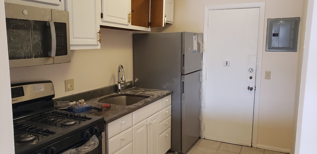 6 Hayes Road, Unit 25 Boston, MA 02131 - Photo 28 of 39 a kitchen with stainless steel appliances granite countertop a refrigerator and a stove