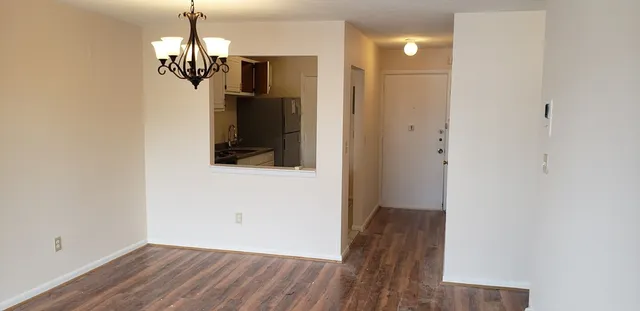 a view of a room with wooden floor