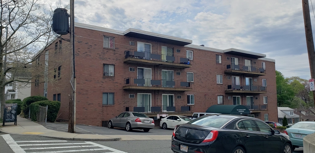 6 Hayes Road, Unit 25 Boston, MA 02131 - Photo 3 of 39 a front view of a building with parking space