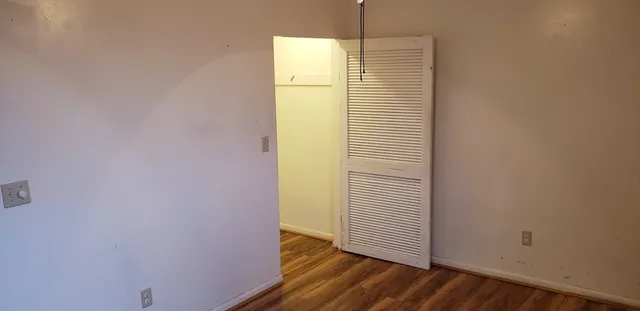 a view of a room with wooden floor