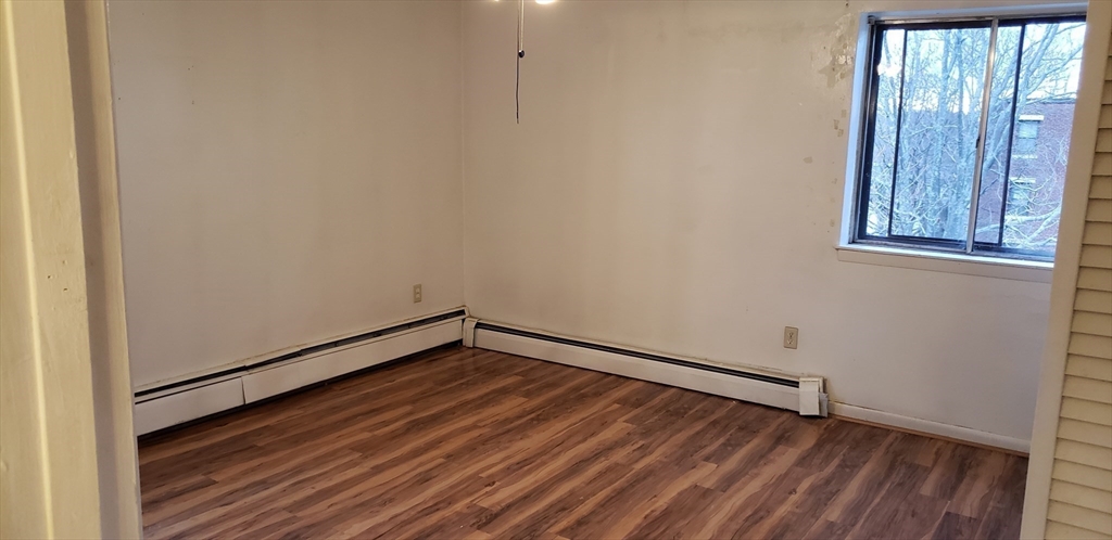 6 Hayes Road, Unit 25 Boston, MA 02131 - Photo 7 of 39 a view of a room with wooden floor and white walls