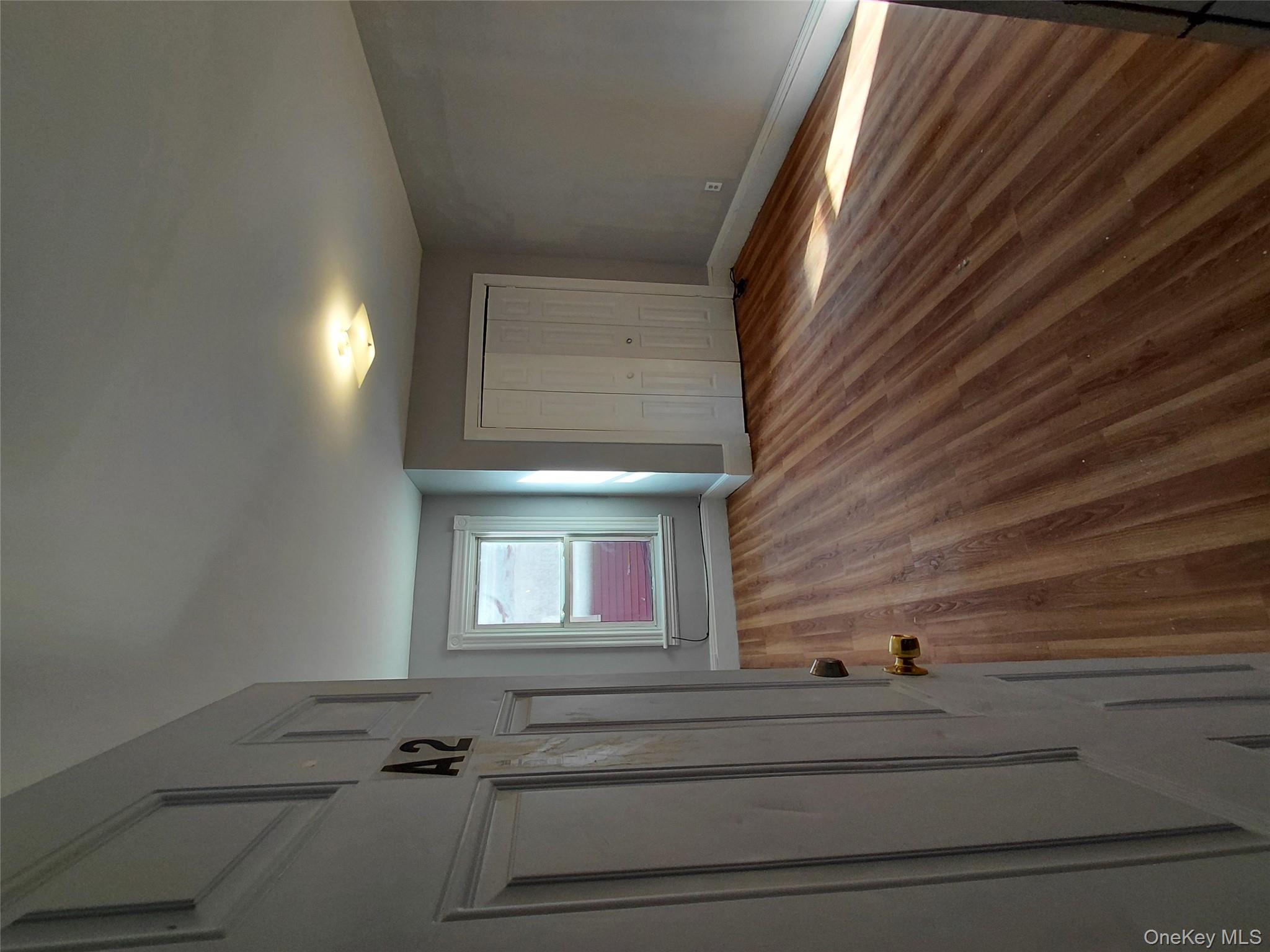 67 Greenkill Avenue, Unit A2 Kingston, NY 12401 - Photo 7 of 13 Unfurnished bedroom featuring wood finished floors and a closet