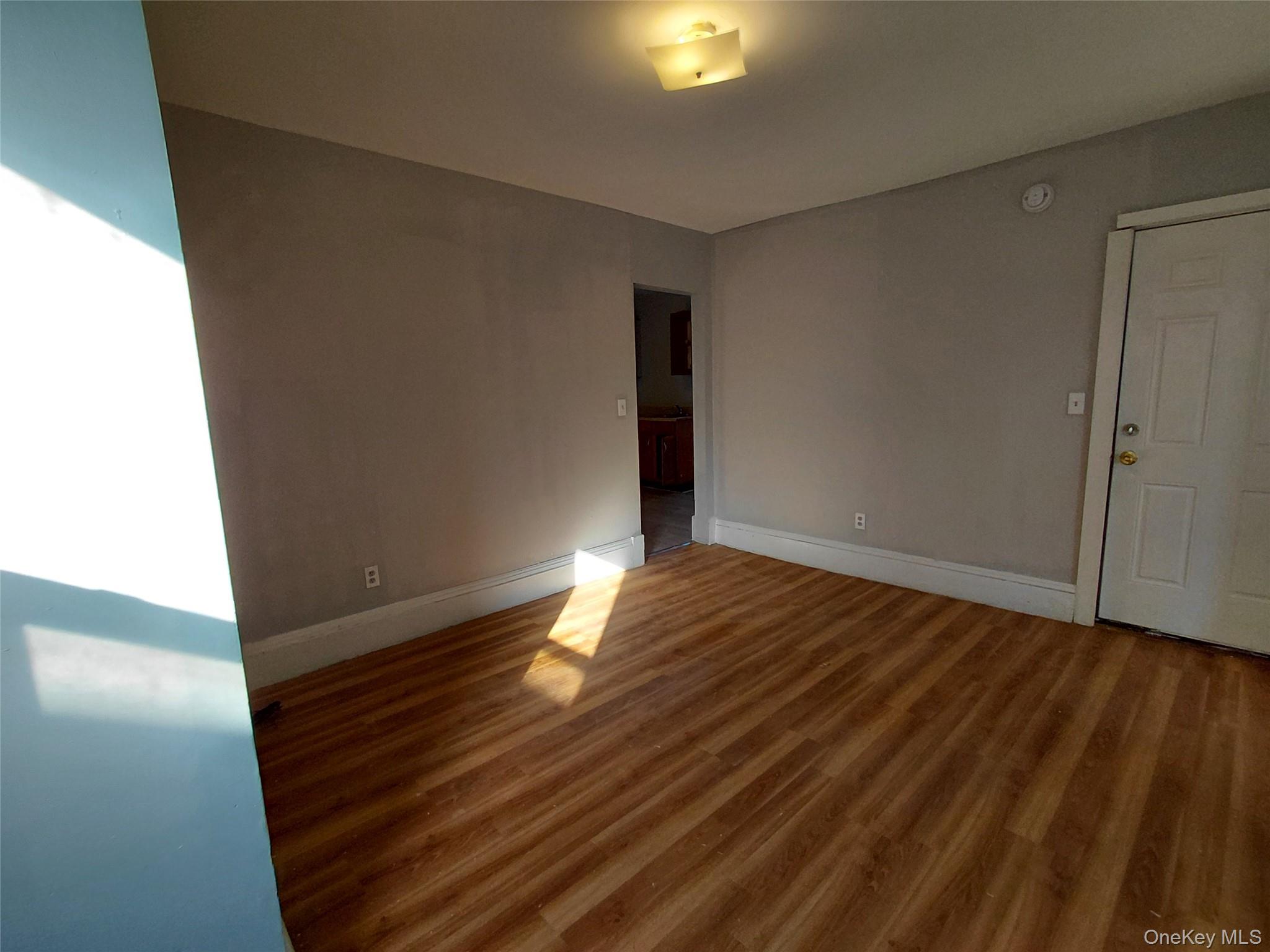 67 Greenkill Avenue, Unit A2 Kingston, NY 12401 - Photo 8 of 13 Spare room featuring baseboards and wood finished floors