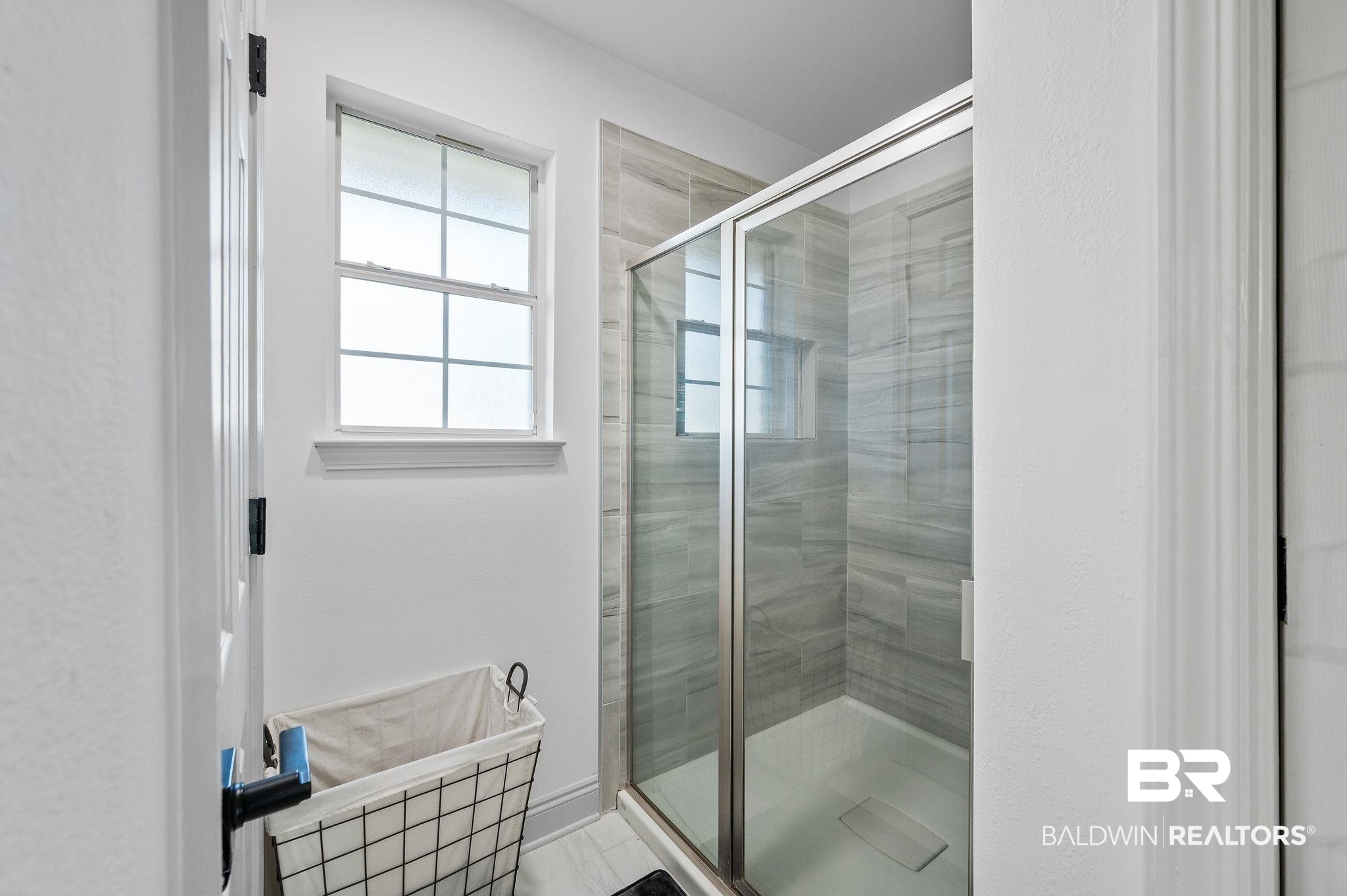 136 Destrehan Road Fairhope, AL 36532 - Photo 28 of 44 Bathroom featuring tile patterned floors and a shower with door