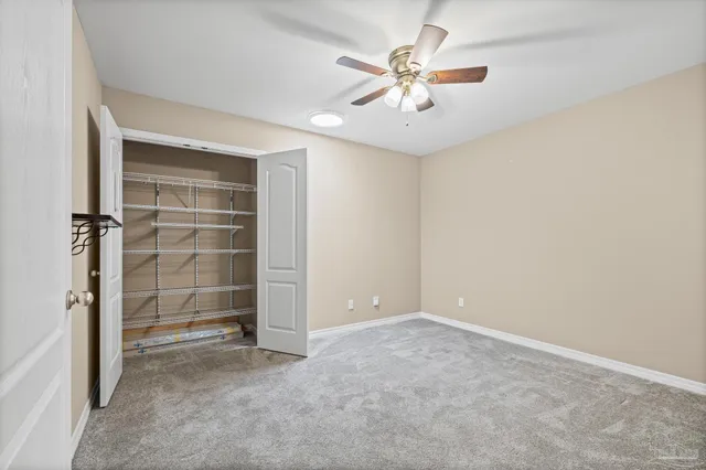 a bathroom with a double vanity sink a toilet a mirror and shower