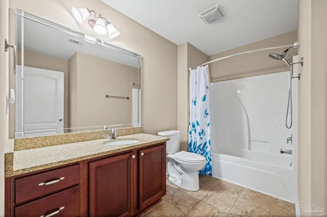 an empty room with closet and a chandelier fan