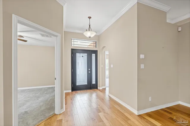 a view of empty room with wooden floor