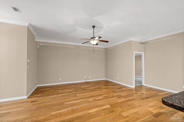 a view of a kitchen with kitchen island stainless steel appliances refrigerator stove microwave and cabinets