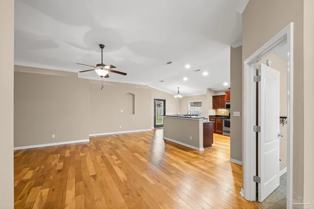 a kitchen with stainless steel appliances granite countertop a stove a sink and a refrigerator