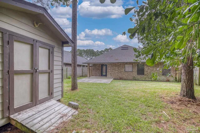 a front view of a house with a garden and trees