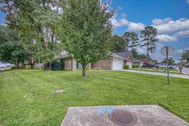 a front view of house with yard and green space