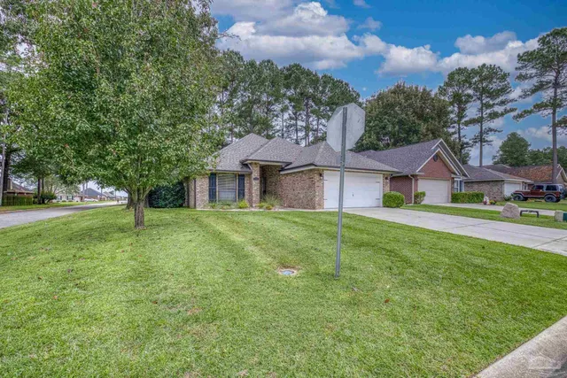 a front view of house with yard and green space