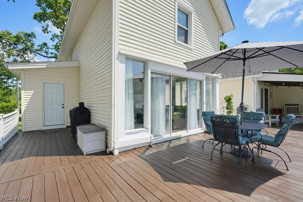 23055 Snell Road Columbia Station, OH 44028 - Photo 37 of 50 Expansive outdoor deck featuring wood-finish flooring, white siding, and direct access to interior spaces through large sliding glass doors