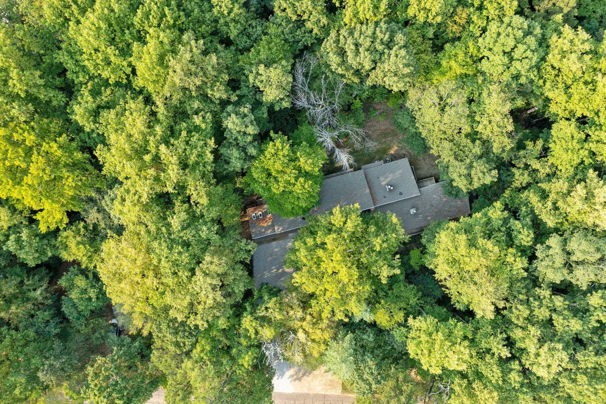 an aerial view of a house with a yard and garden space