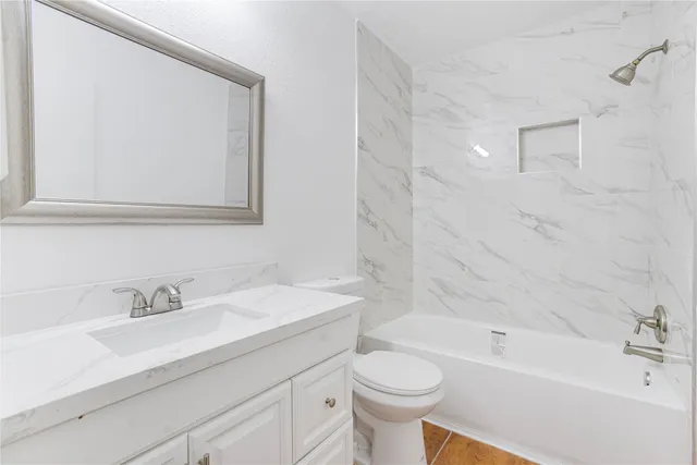 a bathroom with a sink toilet a bathtub and shower