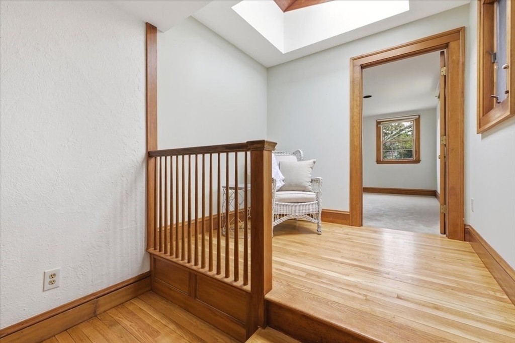 238 Harris Avenue Needham, MA 02492 - Photo 18 of 35 a view of a hallway with wooden floor and a bathroom