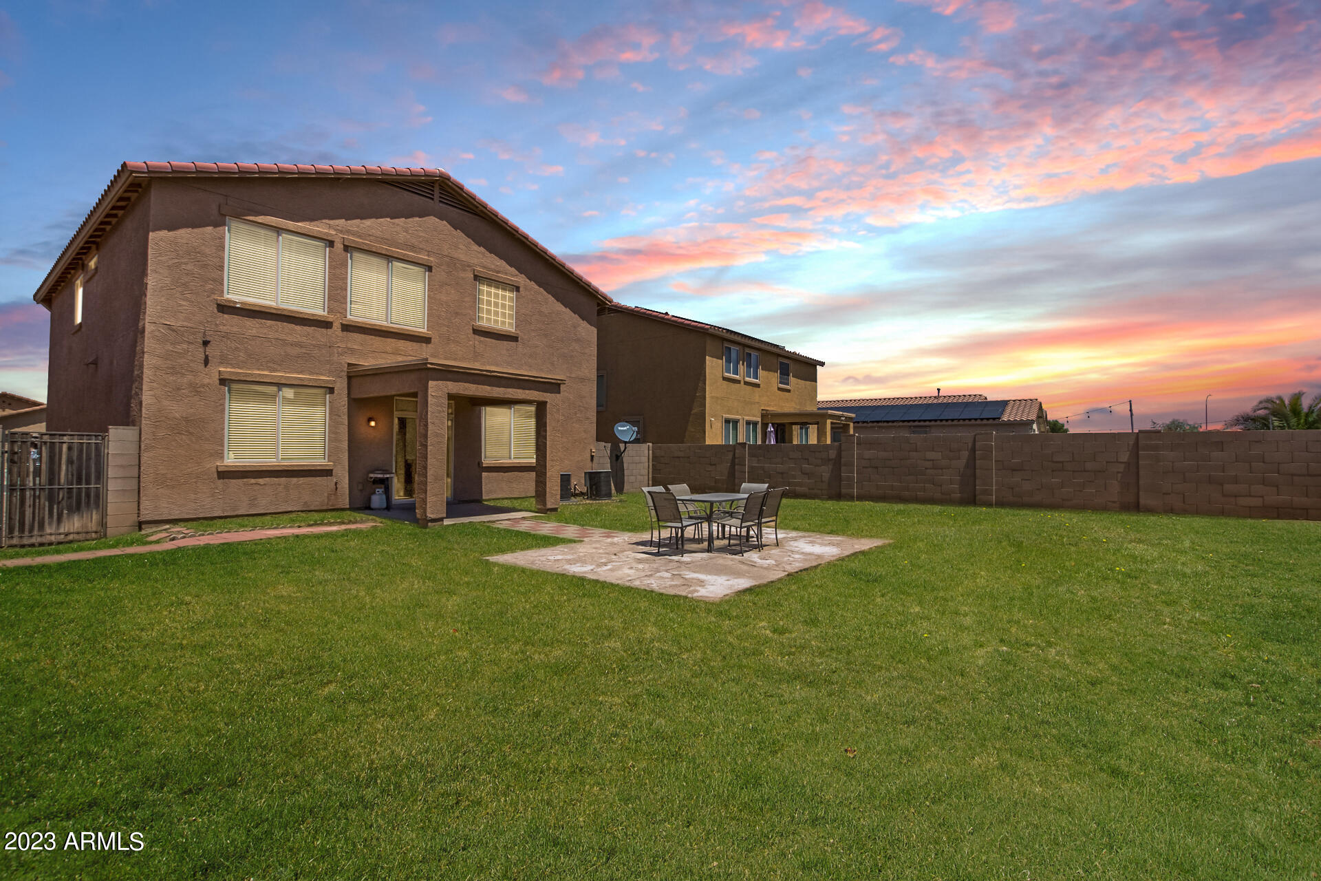 7317 West Darrel Road Laveen, AZ 85339 - Photo 2 of 13 a front view of a house with swimming pool having outdoor seating
