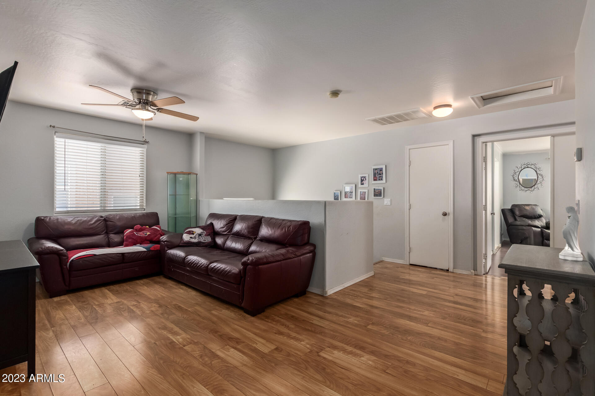 7317 West Darrel Road Laveen, AZ 85339 - Photo 9 of 13 a living room with furniture and a wooden floor