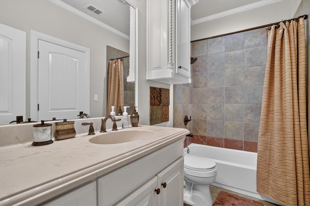 100 Canyon Ridge Trail Aledo, TX 76008 - Photo 19 of 38 White vanity with an integrated sink, bronze-finish faucet, and light-colored countertop