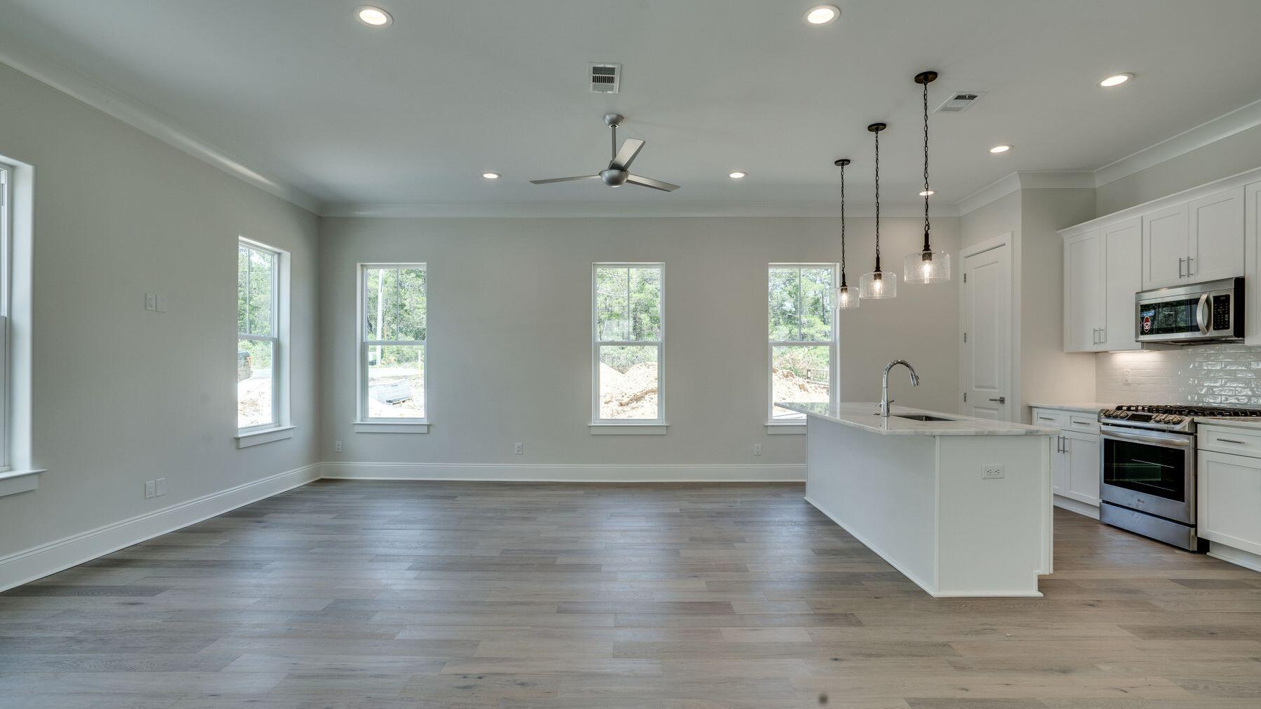 68 Sunset Key Inlet Beach, FL 32461 - Photo 4 of 29 a kitchen with stainless steel appliances granite countertop a stove top oven a sink dishwasher a refrigerator and white cabinets with wooden floor