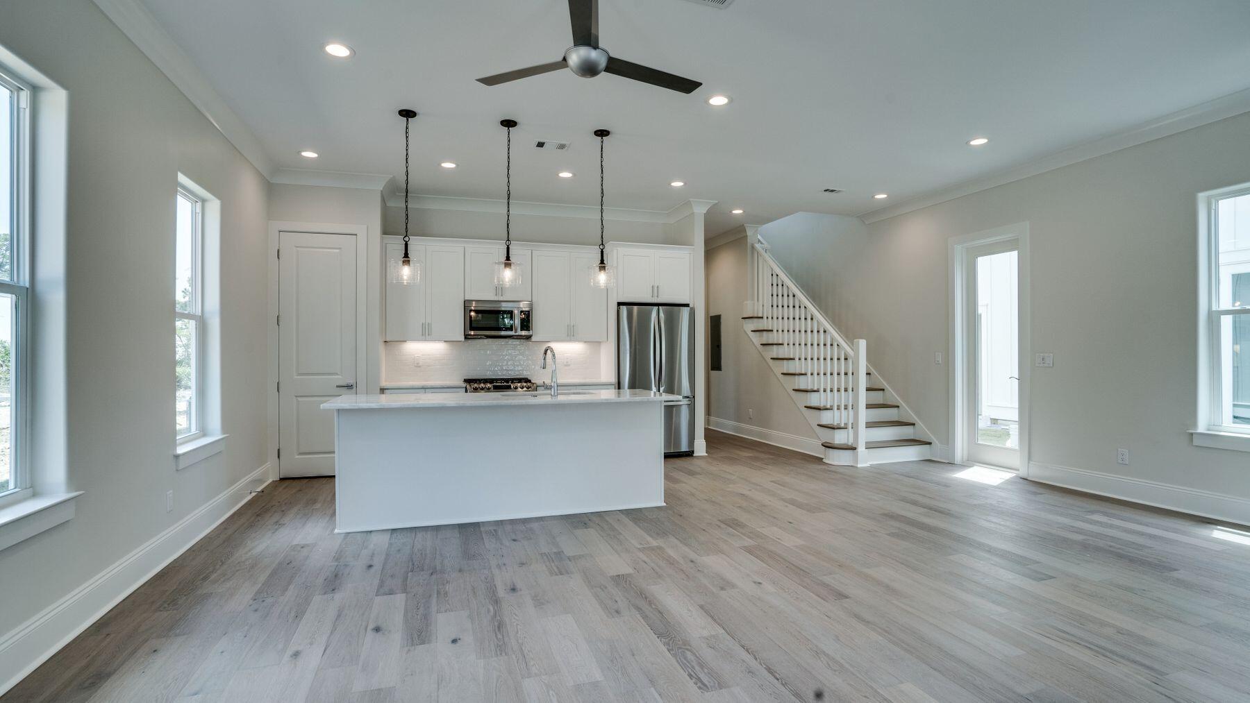 68 Sunset Key Inlet Beach, FL 32461 - Photo 5 of 29 a kitchen with stainless steel appliances granite countertop wooden floors sink and cabinets