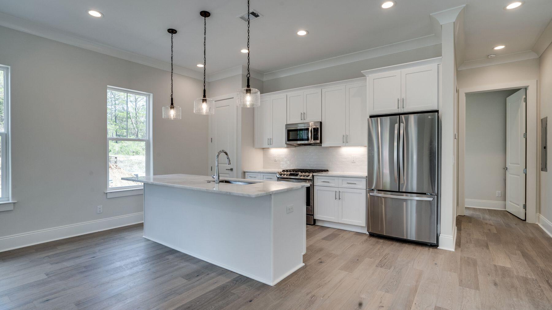 68 Sunset Key Inlet Beach, FL 32461 - Photo 6 of 29 a kitchen with stainless steel appliances granite countertop a refrigerator a sink dishwasher a oven and white cabinets with wooden floor