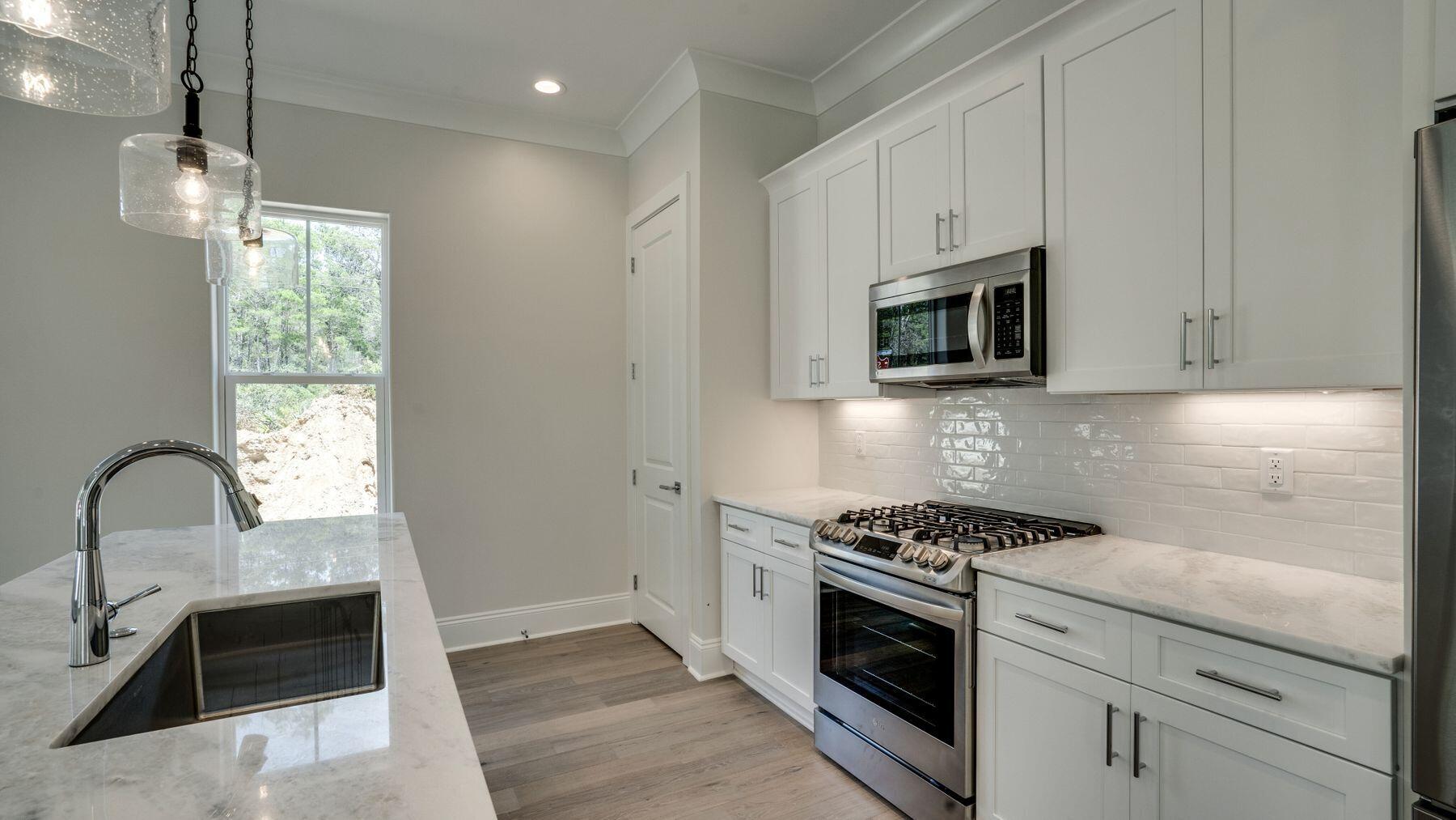 68 Sunset Key Inlet Beach, FL 32461 - Photo 7 of 29 a kitchen with granite countertop white cabinets and appliances