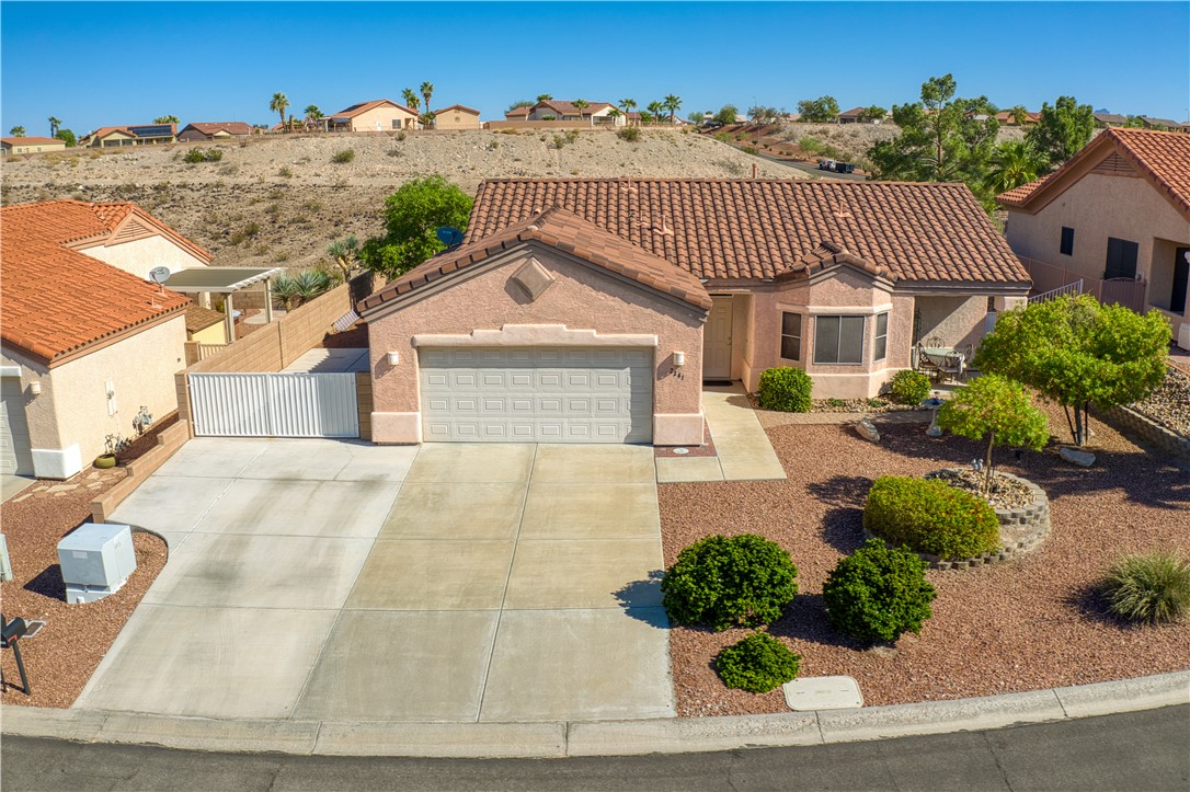 Mediterranean / spanish-style home featuring stucco siding, an attached garage, and concrete driveway