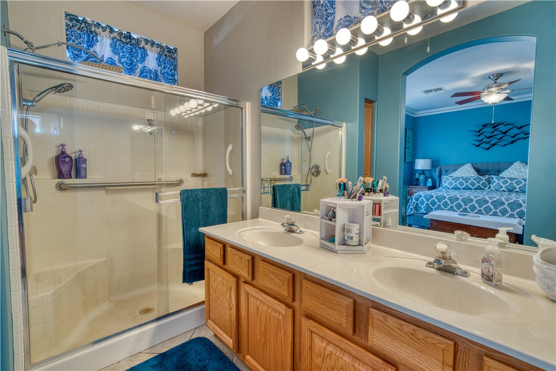 2341 Half Moon Way Bullhead City, AZ 86442 - Photo 12 of 35 Bathroom with ensuite bath, a stall shower, double vanity, light tile patterned flooring, and a ceiling fan