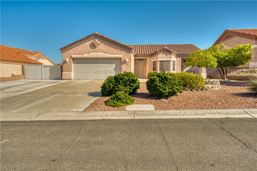 2341 Half Moon Way Bullhead City, AZ 86442 - Photo 2 of 35 Mediterranean / spanish-style house with a tile roof, driveway, a garage, and stucco siding