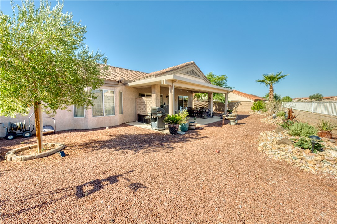 2341 Half Moon Way Bullhead City, AZ 86442 - Photo 25 of 35 Back of house featuring a fenced backyard, stucco siding, a patio area, and a tile roof