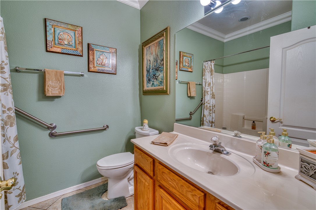 2341 Half Moon Way Bullhead City, AZ 86442 - Photo 7 of 35 Bathroom with crown molding, vanity, light tile patterned floors, a textured wall, and a shower with curtain
