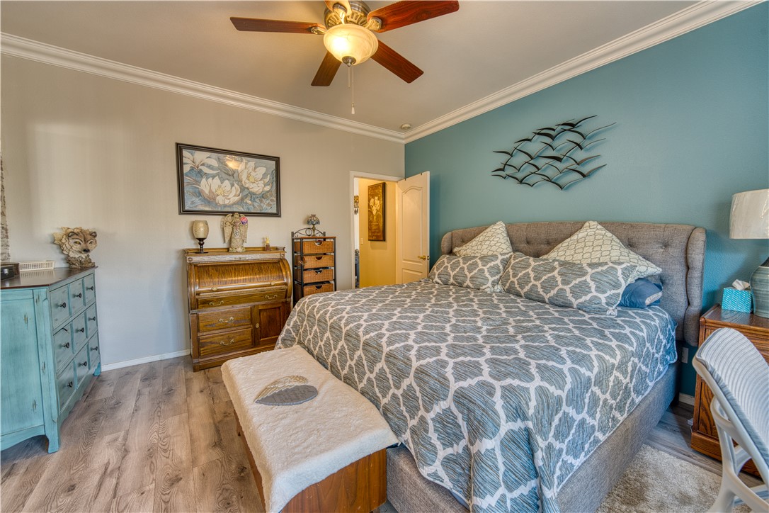 2341 Half Moon Way Bullhead City, AZ 86442 - Photo 10 of 35 Bedroom featuring ornamental molding, light wood-style floors, and a ceiling fan