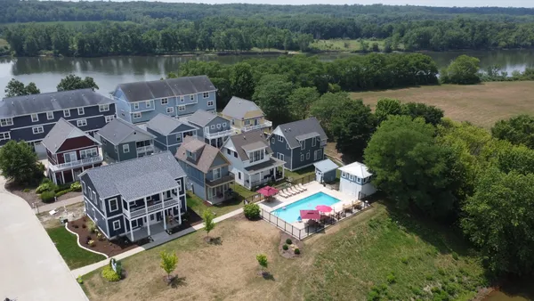 an aerial view of a house with pool lake view and mountain view