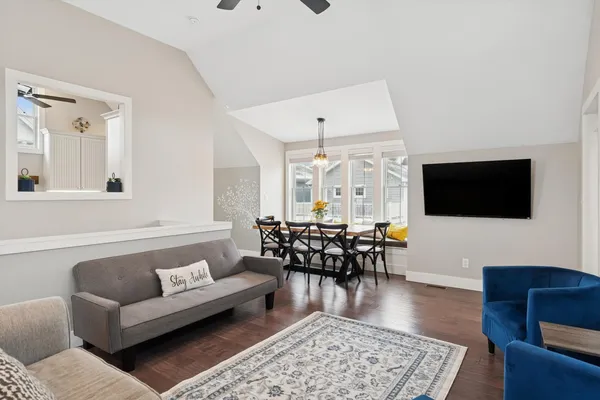 a living room with furniture wooden floor and a flat screen tv