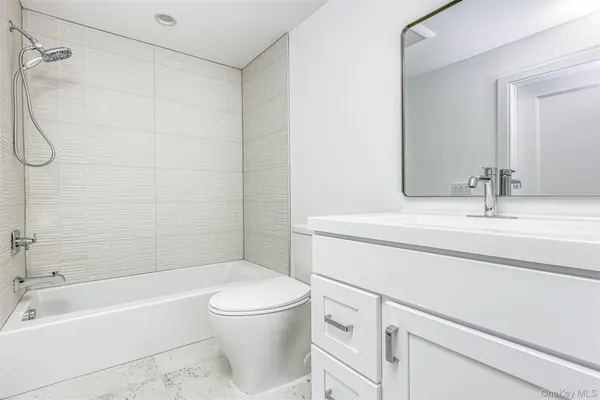 a bathroom with a sink a toilet and a bathtub