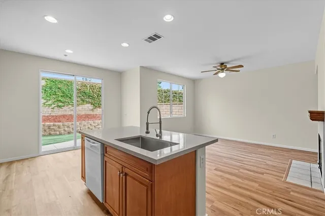 a kitchen with a sink cabinets and wooden floor