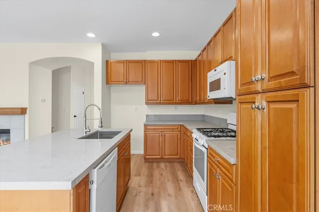 a kitchen with stainless steel appliances granite countertop a sink a stove and a refrigerator