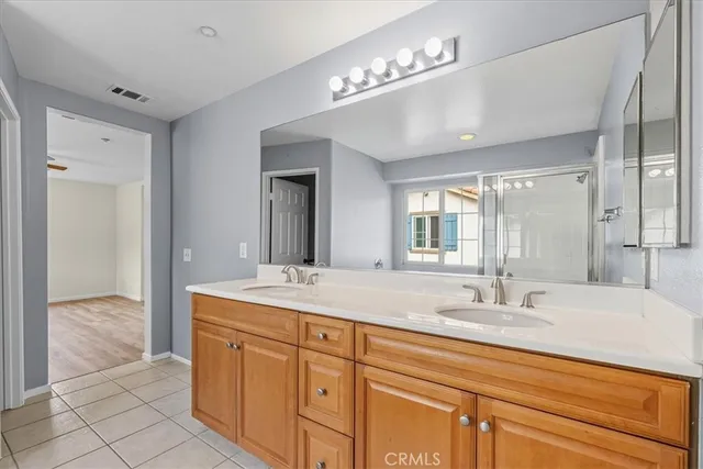 a bathroom with a sink double vanity and a mirror
