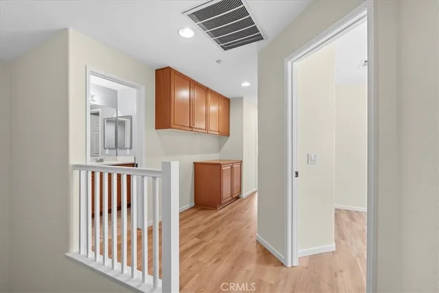 a view of a hallway with entryway wooden floor and front door