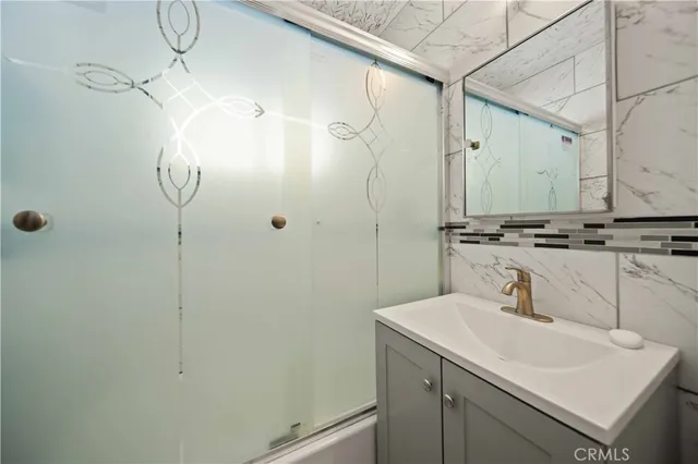 a bathroom with a sink mirror and vanity
