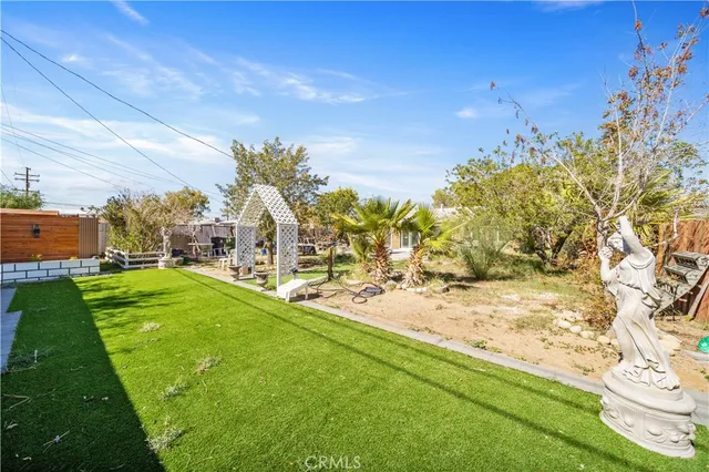 a view of a yard with yellow house
