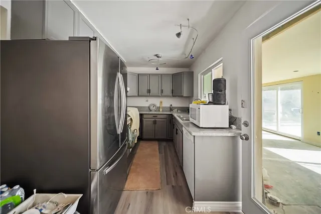 a kitchen with refrigerator a washer and dryer