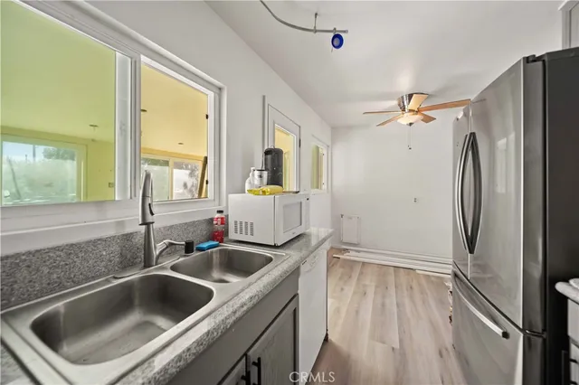 a kitchen with a sink and refrigerator