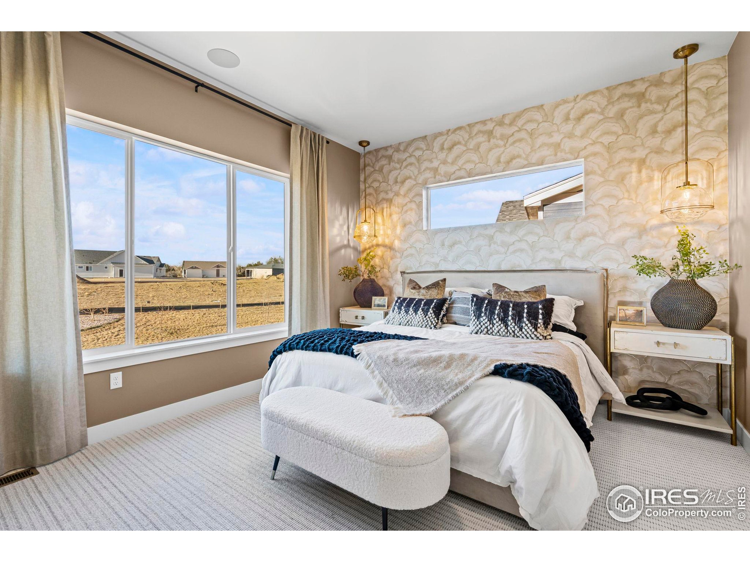 3016 Windward Way Fort Collins, CO 80524 - Photo 22 of 49 a bedroom with a bed and a large window