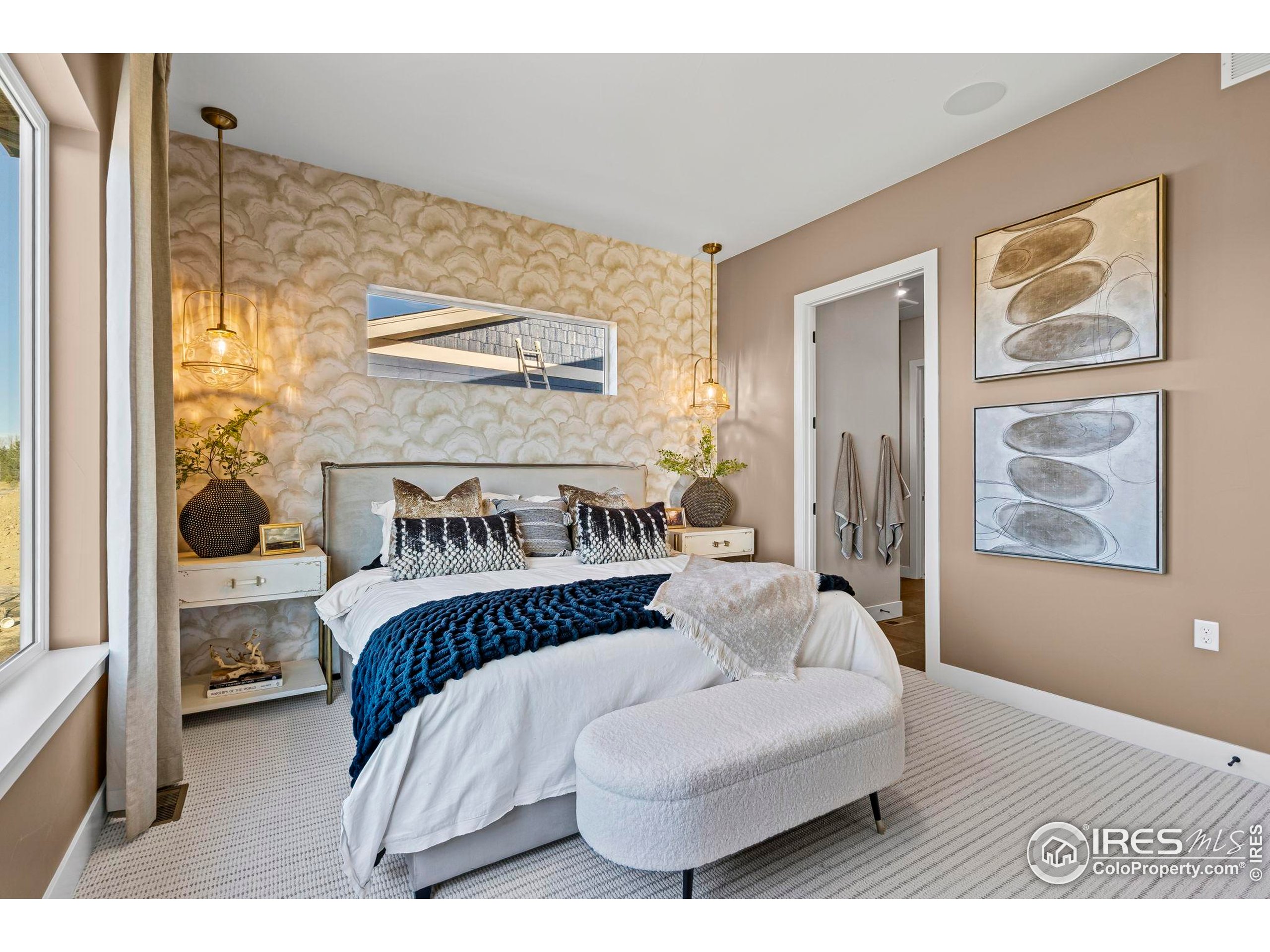 3016 Windward Way Fort Collins, CO 80524 - Photo 23 of 49 a spacious bedroom with a bed and a painting on the wall