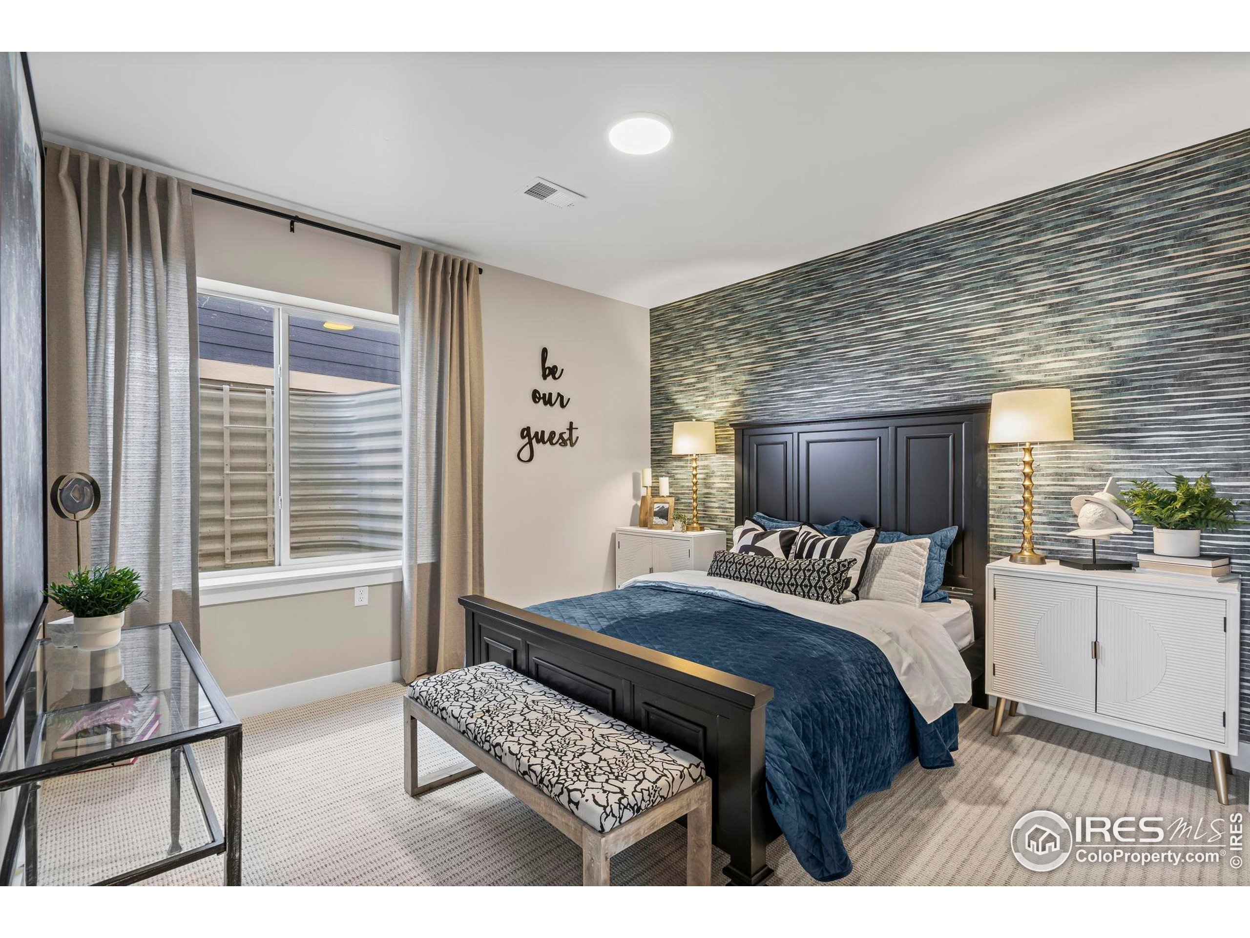 3016 Windward Way Fort Collins, CO 80524 - Photo 39 of 49 a bedroom with a bed wooden floor and window