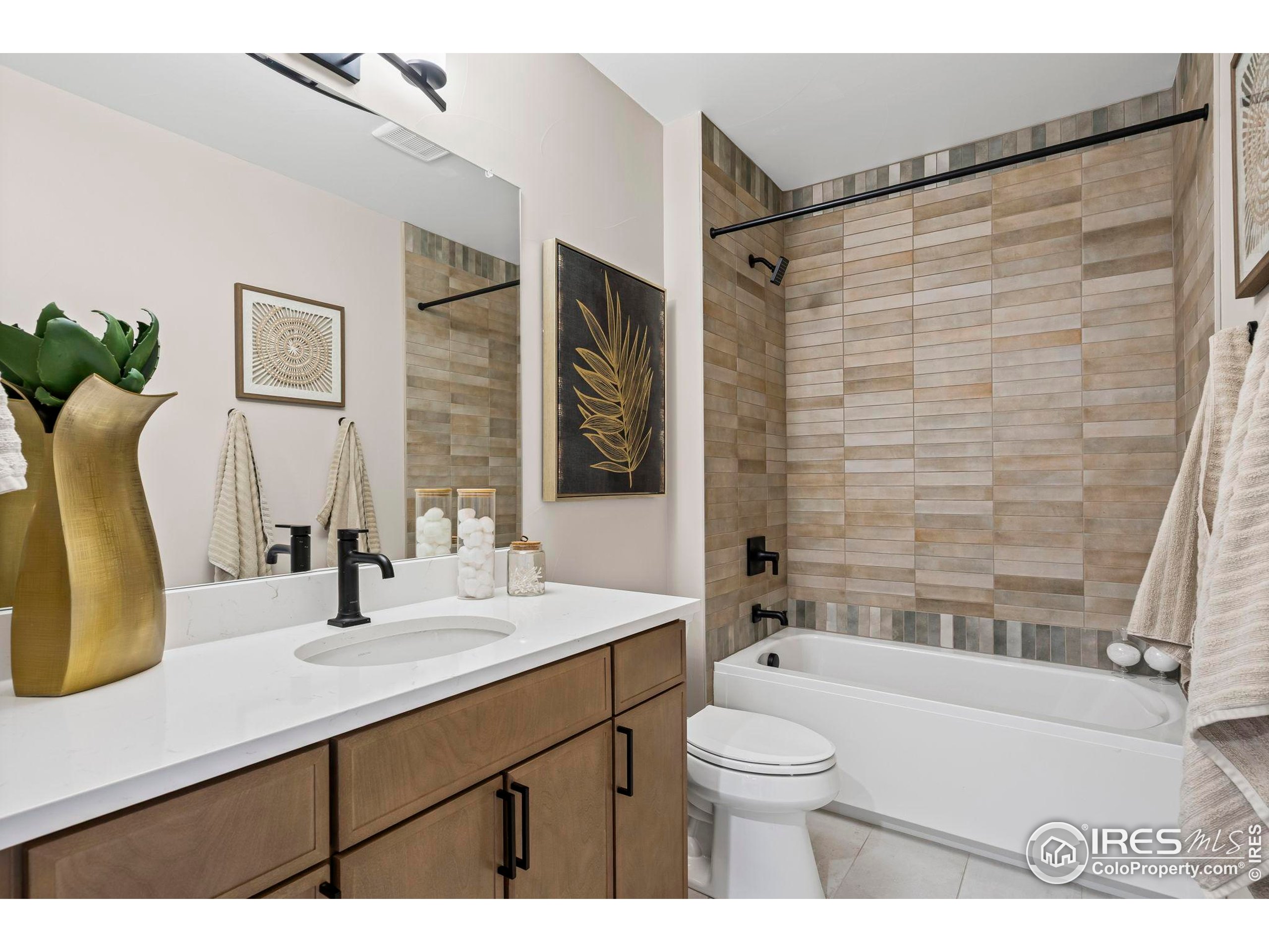 3016 Windward Way Fort Collins, CO 80524 - Photo 40 of 49 a bathroom with a double vanity sink toilet mirror and shower